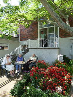 Rest home in Auckland - Women sitting around table in outdoor area